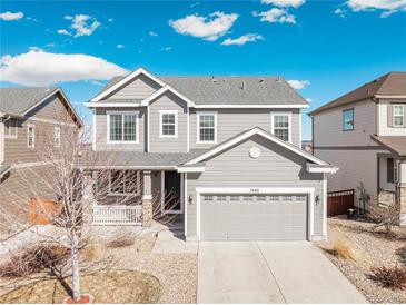 Charming two-story home with a well-manicured front yard and attached two-car garage at 7686 Grady Cir, Castle Rock, CO 80108