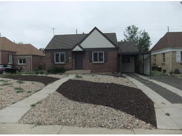 Charming brick home featuring a well maintained yard and driveway leading to a covered parking area at 3243 Albion St, Denver, CO 80207