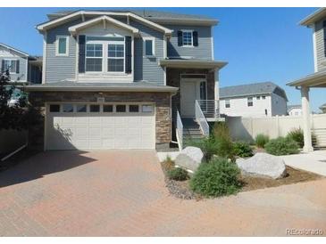 Charming two-story home with stone accents and a brick driveway, perfect for suburban living at 4551 N Quemoy St, Aurora, CO 80019