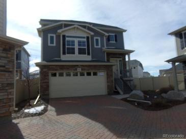 Charming two-story home with attached two-car garage and manicured landscaping at 4551 N Quemoy St, Aurora, CO 80019