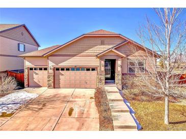 Ranch style home with two-car garage and landscaped yard at 77 N Irvington St, Aurora, CO 80018