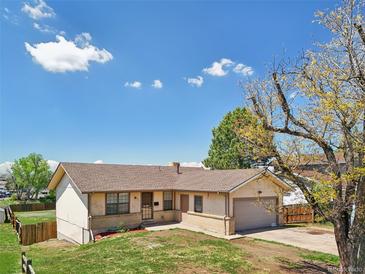 Charming one-story home with a well-maintained lawn and an attached one car garage at 831 Sable Blvd, Aurora, CO 80011