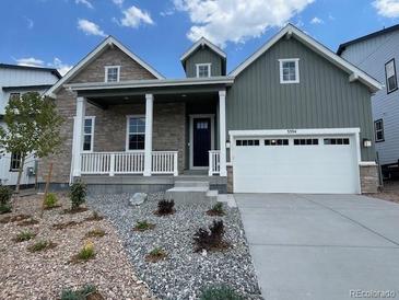 Charming two-story home featuring a covered porch and a two-car garage at 3394 Backdrop Ct, Castle Rock, CO 80108