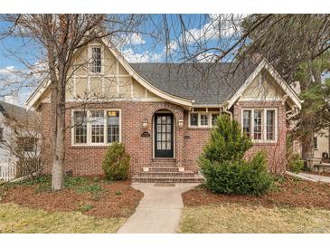 Charming brick home featuring an arched entryway and well-manicured landscaping at 446 N Marion St, Denver, CO 80218