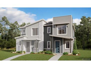 Modern two-story home with gray siding and a landscaped lawn at 22841 E Stanford Ln # A, Aurora, CO 80015