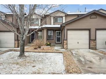 Charming townhome with a private garage and well-maintained front yard at 371 Smith Cir, Erie, CO 80516
