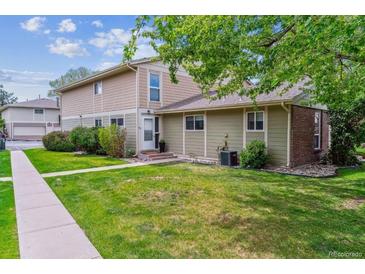 Charming home exterior with a well-manicured lawn and mature trees offering shade at 6650 E Arizona Ave # 154, Denver, CO 80224