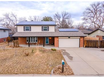 Charming two-story brick home with solar panels and attached two-car garage at 6410 S Kendall St, Littleton, CO 80123