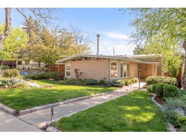 Charming mid-century home featuring a brick facade, mature trees, and a well-manicured lawn at 3242 4Th St, Boulder, CO 80304