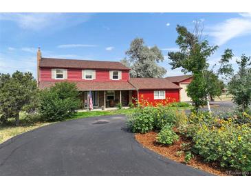 Charming red two-story home with stone accents, mature landscaping, and a circular driveway at 20155 E Davies Ave, Centennial, CO 80016