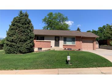 Charming brick home with a well-maintained lawn and mature evergreen tree in a desirable neighborhood at 2797 S Newton Way, Denver, CO 80236