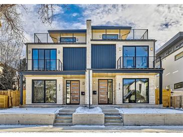 Modern duplex featuring stone facade, black framed windows, steel railings, and individual entrance for each residence at 374 S Humboldt St, Denver, CO 80209