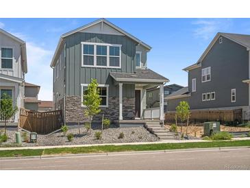Charming two-story home featuring stone accents and manicured landscaping at 20871 E 60Th Ave, Aurora, CO 80019
