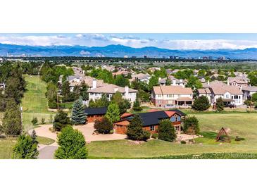 Expansive real estate with lush green lawns, mature trees, and mountain views on the horizon at 6191 S Olathe St, Centennial, CO 80016