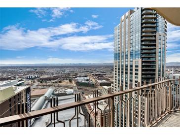 Breathtaking city view from the balcony of a modern high-rise condo against a cloudy sky at 1020 15Th St # 42A, Denver, CO 80202