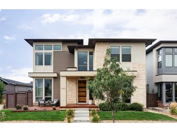 Modern two-story home with stone accents and a landscaped front yard at 9385 E 58Th Dr, Denver, CO 80238