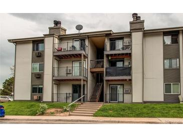 Attractive multi-story condo building with private balconies and well-maintained landscaping at 2280 S Oswego Way # 303, Aurora, CO 80014
