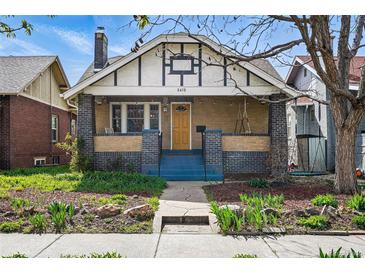 Charming brick home with a welcoming front porch and manicured landscaping at 3415 N Vine St, Denver, CO 80205