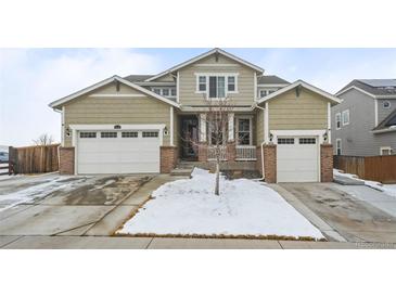 Charming two-story home with a two-car garage and landscaped front yard at 14119 Glencoe St, Thornton, CO 80602