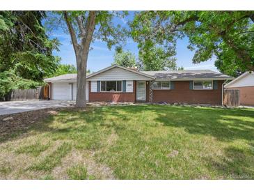 Charming brick ranch-style home with a well-maintained lawn and mature trees providing ample shade at 3784 Swadley St, Wheat Ridge, CO 80033