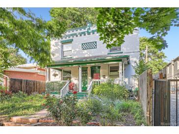 Charming two-story home with a welcoming front porch and vibrant garden, showcasing curb appeal and inviting outdoor space at 1612 N High St, Denver, CO 80218