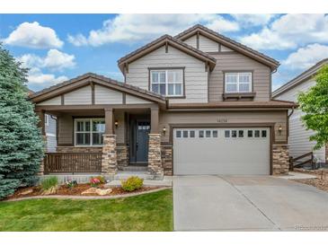 Charming two-story home featuring a covered porch and a well-maintained lawn, perfect for suburban living at 14258 Greenfield Loop, Parker, CO 80134