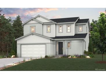 Charming two-story home with a well-manicured lawn, attached two-car garage, and welcoming entrance at 1341 Loraine N Cir, Lafayette, CO 80026