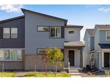 A modern two-story home featuring a stylish gray exterior, well-maintained lawn, and inviting front entrance at 1443 Great Western Dr, Longmont, CO 80501