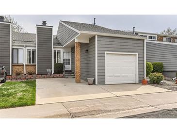 Charming home featuring gray siding, a one-car garage, brick accents, and a well-maintained front yard at 3798 E 118Th Way, Thornton, CO 80233
