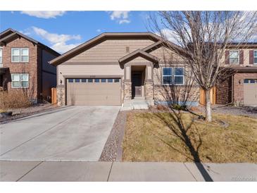 Charming single-Gathering home featuring a two-car garage and stone accents on a well-maintained lawn at 25127 E Maple Ave, Aurora, CO 80018