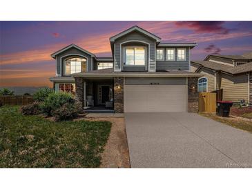 Inviting two-story home boasts a neutral color palette, a two-car garage, and a well-maintained front yard at 17464 Crestview Ct, Monument, CO 80132