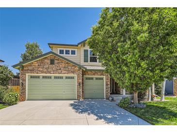 Charming two-story home with a stone facade and a three-car garage, perfect for a Gathering at 13962 Dexter Way, Thornton, CO 80602