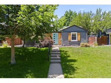 Charming home with a well-manicured front yard, steps to front door, and updated exterior finishes at 4451 Eliot St, Denver, CO 80211