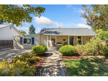 Charming single-story home featuring a well-manicured yard and welcoming front porch with seating at 1253 Uinta St, Denver, CO 80220