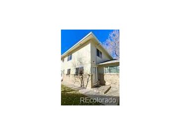 Charming townhouse featuring a well-maintained lawn and neutral-colored exterior paint at 7309 W Hampden Ave # 5202, Lakewood, CO 80227