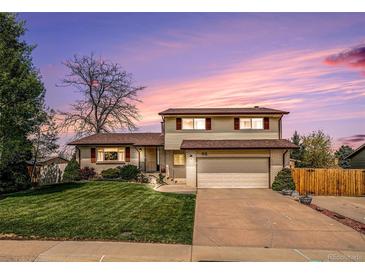 Charming two-story home with a well-maintained lawn and attached two-car garage at 92 Helena Cir, Littleton, CO 80124