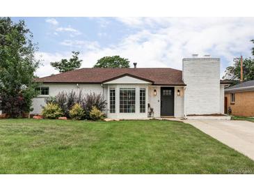 Charming single-story home featuring a well-maintained front lawn, white brick, and beautiful bay window at 2941 Oneida St, Denver, CO 80207