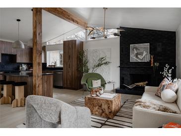 Bright living room featuring a fireplace, modern lighting, and unique architectural details at 1560 S Forest St, Denver, CO 80222