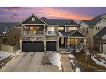 Beautiful two-story home with stone accents, a covered porch and two-car garage at 4981 Liverpool St, Denver, CO 80249