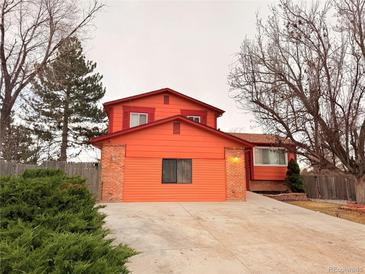 Charming two-story home featuring an attached two car garage and a spacious concrete driveway at 10010 Columbine Ct, Thornton, CO 80229