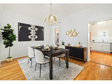 Beautiful dining room with modern chandelier, stylish decor, and hardwood floors at 1748 W 36Th Ave, Denver, CO 80211