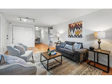 Cozy living room featuring comfortable seating, modern decor, and lots of natural light, perfect for relaxing or entertaining guests at 3047 W 47Th Ave # 112, Denver, CO 80211