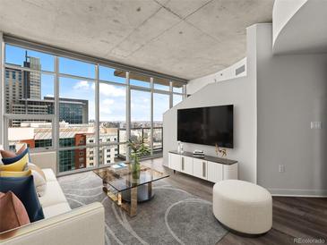 Bright living room with floor-to-ceiling windows offering expansive city views and stylish modern decor at 891 14Th St # 2314, Denver, CO 80202