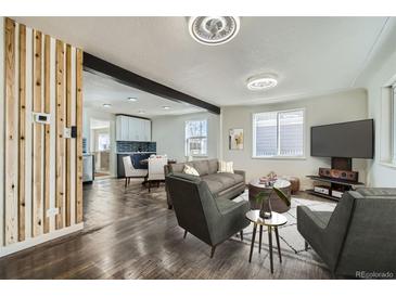 Bright and airy living room featuring an open floor plan, modern furnishings and stylish decor throughout at 5050 Steele St, Denver, CO 80216
