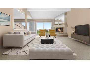 Bright living room with fireplace, plush seating, and sliding doors to outdoor view at 7160 W Stetson Pl # 27, Littleton, CO 80123