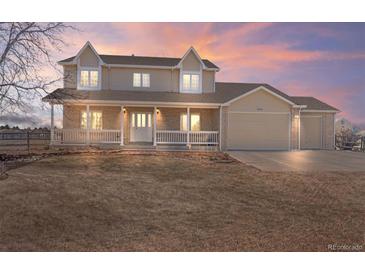 Charming two-story home with a welcoming front porch and a three car garage at 15543 Quivas St, Broomfield, CO 80023
