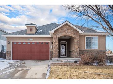 Ranch style home with stone accents and a two-car garage at 6321 Spring Gulch St, Frederick, CO 80516