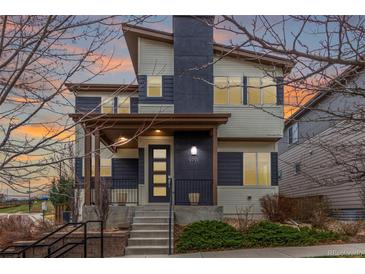 Stylish two-story home featuring a modern design with a covered front porch and manicured landscaping at 9791 Dunning Cir, Highlands Ranch, CO 80126