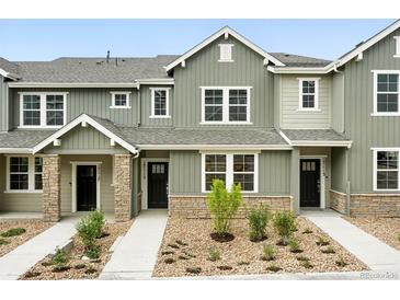 Charming townhome featuring neutral exteriors, landscaping, and inviting entrances at 17115 W 91St Ln, Arvada, CO 80007