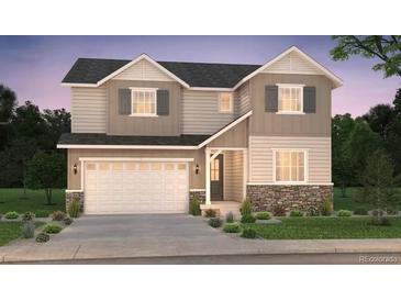 Charming two-story home featuring stone accents, a two-car garage, and manicured landscaping at 2197 S Jackson Gap St, Aurora, CO 80018